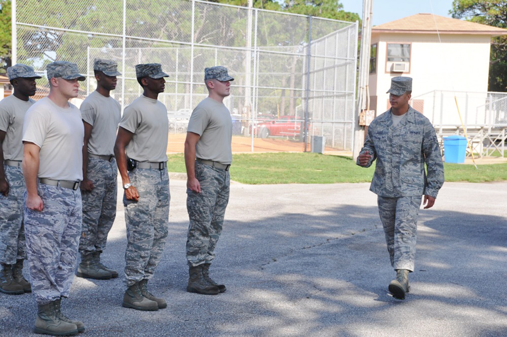 Airman 1st Class Justin Baker calls basic commands to Tyndall Air Force Base Honor Guard Airmen to practice for active-duty funeral ceremonies July 21, 2010, at Tyndall AFB, Fla. Airmen participated in a week-long training course to improve their skill and give them the ability to teach others. Airman Baker is a visiting United States Air Force Honor Guard instructor. (U.S. Air Force photo/Senior Airman Kirsten Wicker)