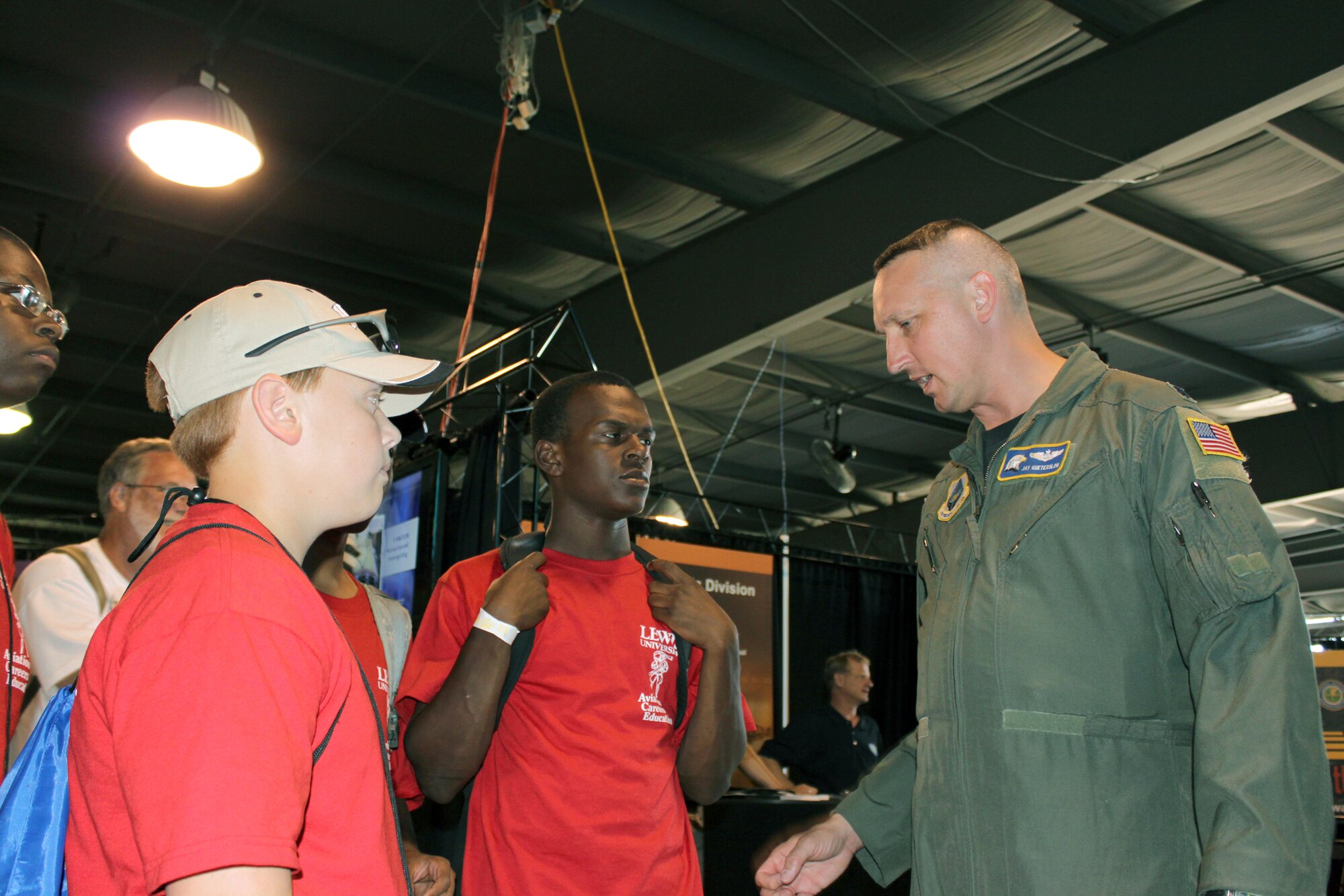 Lt. Col. Jay Guetersloh, the remotely piloted vehicle safety branch chief at the Air Force Safety Center at Kirtland Air Force Base, N.M., describes Air Force RPA operations and safety to a group of teenage students involved in an aviation awareness camp July 29, 2010, during the Experimental Aircraft Association's Airventure 2010 at Oshkosh, Wis. (U.S. Air Force photo/Capt. Al Bosco)