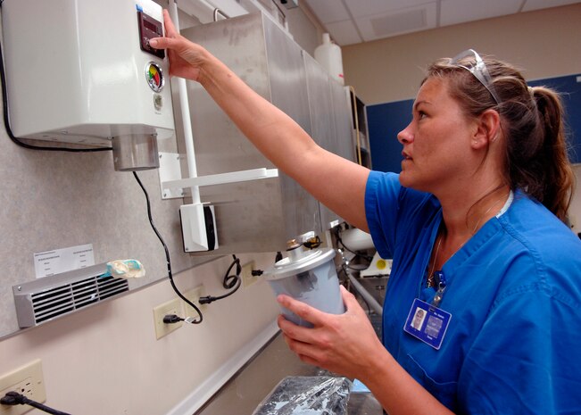 Kathy Dietrich starts a vacuspate to suck the air out of a mixing stone at the Deily Dental Clinic June 8, 2010, on Joint Base Charleston, S.C. The vacustpate is used to lessen the chances of air bubbles and imperfections during the casting of the patients teeth. Mrs. Dietrich is a  dental technician with the 628th Medical Group. (U.S. Air Force photo/Senior Airman Timothy Taylor)