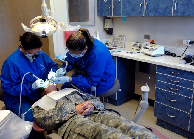 Maj. Courtney Schapira, left, and Kathy Dietrich perform a routine operative procedure at the Deily Dental Clinic June 8, 2010, on Joint Base Charleston, S.C. Major Schapira used a high speed hand piece to locate, remove and refine a tooth to support a filling in the patients mouth. Major Schapira is a general dentist, Mrs. Dietrich is a dental technician, and both are with the 628th Medical Group. (U.S. Air Force photo/Senior Airman Timothy Taylor)