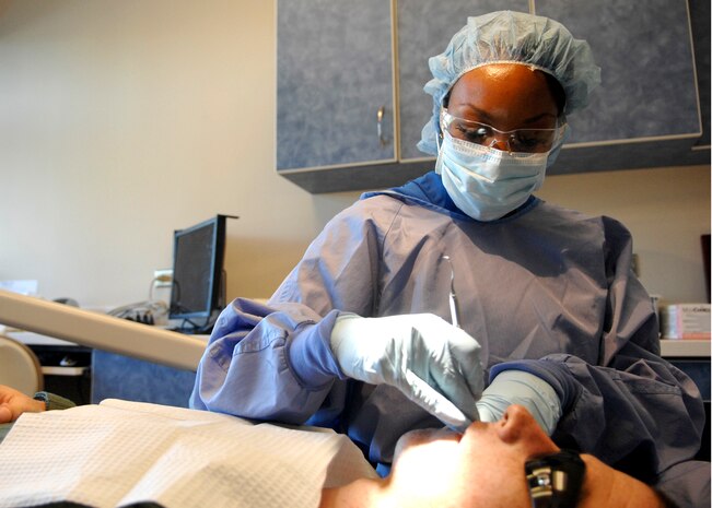 Staff Sgt. Ebony Holt searches for soft spots and cavities in a patients mouth using a dental explorer and mouth mirror at the Deily Dental Clinic June 8, 2010, on Joint Base Charleston, S.C. Prophy technicians help assess patients' teeth and provide basic information for the dentist to perform procedures. The technicians also perform basic cleanings. Sergeant Holt is a dental assistant with the 628th Medical Group. (U.S. Air Force photo/Senior Airman Timothy Taylor)