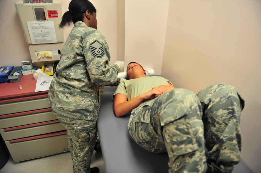 100803-F-8430J-049SHAW AIR FORCE BASE, S.C. -- Master Sgt. Tracy Sankey (left), 20th Medical Operations Squadron immunization technician, helps comfort Airman 1st Class Victoria Secrist, 20th Fighter Wing Public Affairs, after receiving an immunization August 3, 2010. The month of August is National Immunization Awareness Month, which prepares and informs people for the upcoming cold and flu season. Routine immunizations are important in saving lives since they prevent common diseases. (U.S. Air Force photo/Airman 1st Class Amber E. Jacobs)