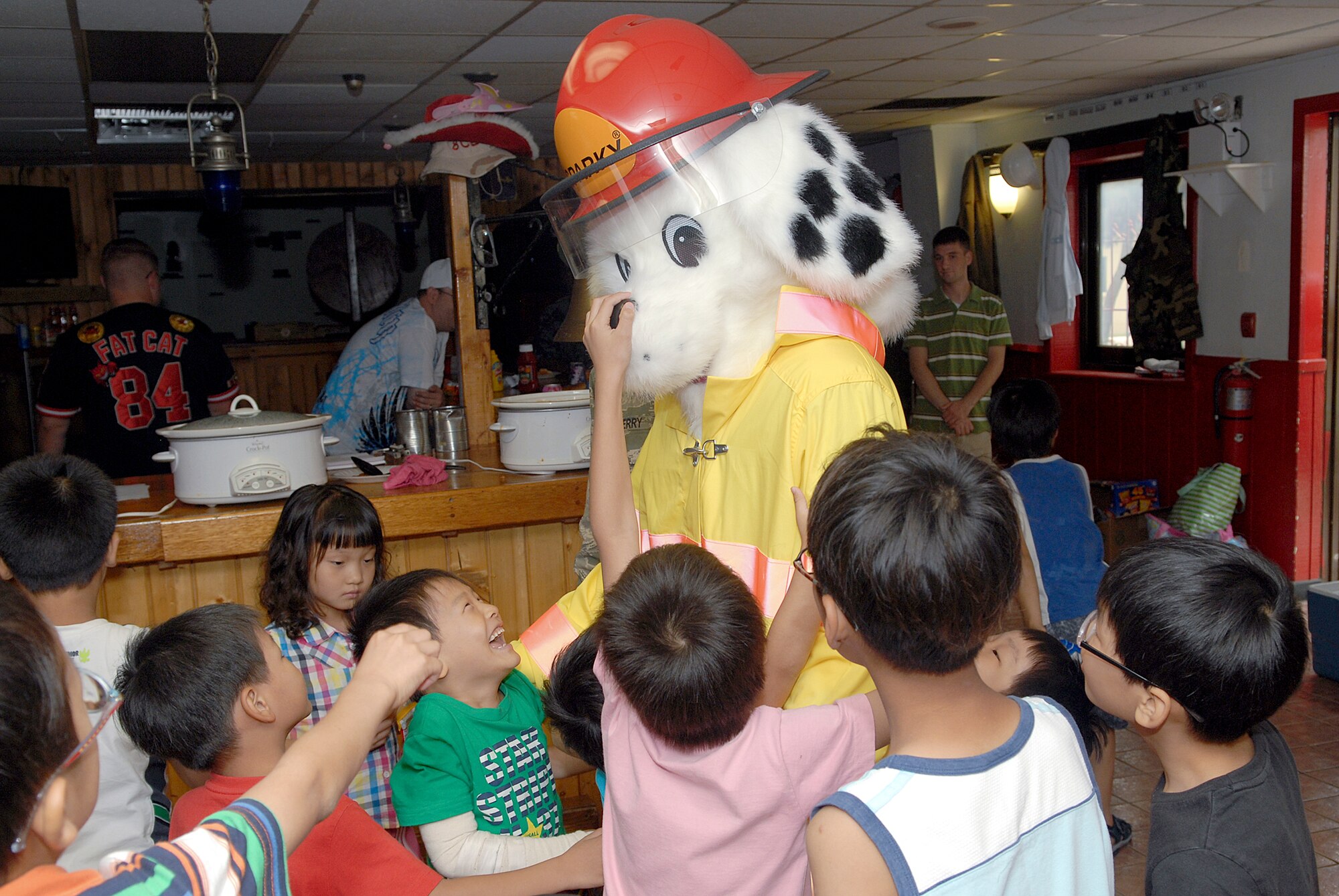 Sparky the Fire Dog visits with children from the Il Mag Won Orphanage during a kid's day July 24, 2010, at Kunsan Air Base, South Korea. (U.S. Air Force photo/Senior Airman Roy Lynch)