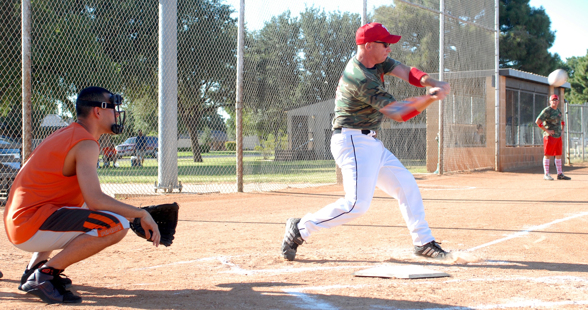 Staff Sgt Kevin Graham, player coach for the 312th Training Squadron softball team, drives the ball into the outfield during an elimination game against the 344th Military Intelligence Battalion softball team.  The 312th went on to knock the Army out the base intramural softball tournament by beating them 14 -7. (U.S. Air Force photo/Master Sgt Randy Mallard)
