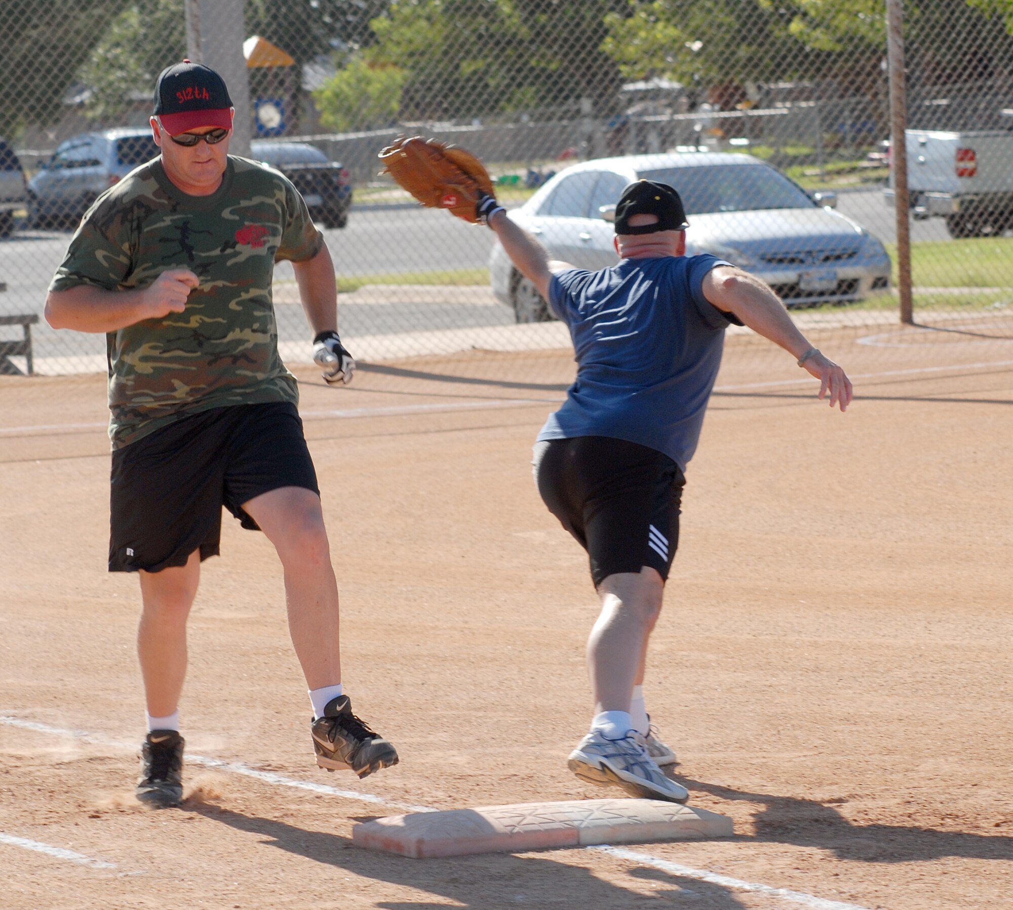 Mark Seal, pitcher for the 312th Training Squadron softball team, gets thrown out at first during an elimination game against the Army's 344th Military Intelligence Battalion softball team.  The 312th went on to knock the Army out of the Goodfellow intramural softball tournament, beating them 14 -7. (U.S. Air Force photo/Master Sgt. Randy Mallard)