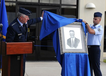 Gen. Roger A. Brady, U.S. Air Forces in Europe commander, unveils a drawing  of Roger M. Blanchard during the dedication of Blanchard Hall August 3 at Randolph Air Force Base, Texas. The portrait of the former Executive Director of the Air Force Personel Center was drawn by General Brady and will be displayed in Blanchard Hall.  General Brady is a former commander of AFPC, and Mr. Blancard was tlhe first civilian executive director. Assisting General Brady is Staff Sgt. Jason LaGueux.  (U.S. Air Force photo/David Terry)
