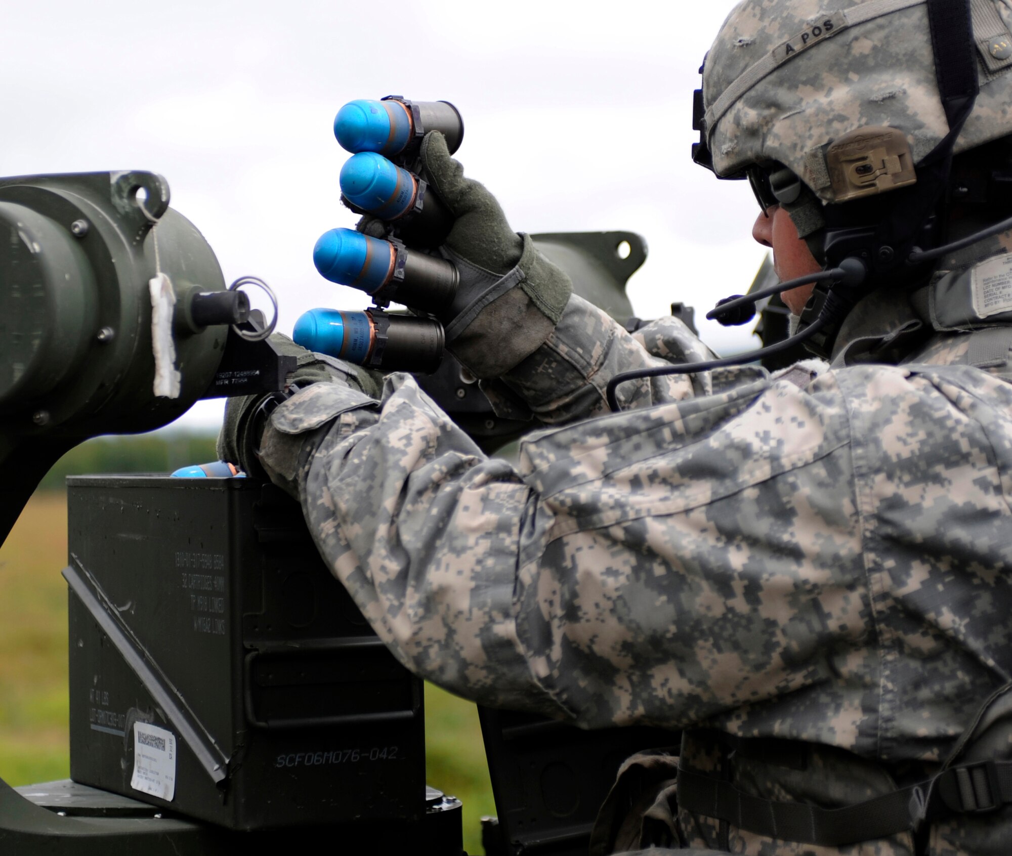 A Soldier loads a 40 mm dummy grenade July 28, 2010, Joint Pacific Alaska Range Complex, Alaska. The ammunition feeds the Mk-19, a belt-fed automatic grenade launcher. The Soldier is assigned to the 1st Brigade, 25th Infantry Division located at Fort Wainwright, Alaska. (U.S. Air Force photo/Airman 1st Class Willard E. Grande II)