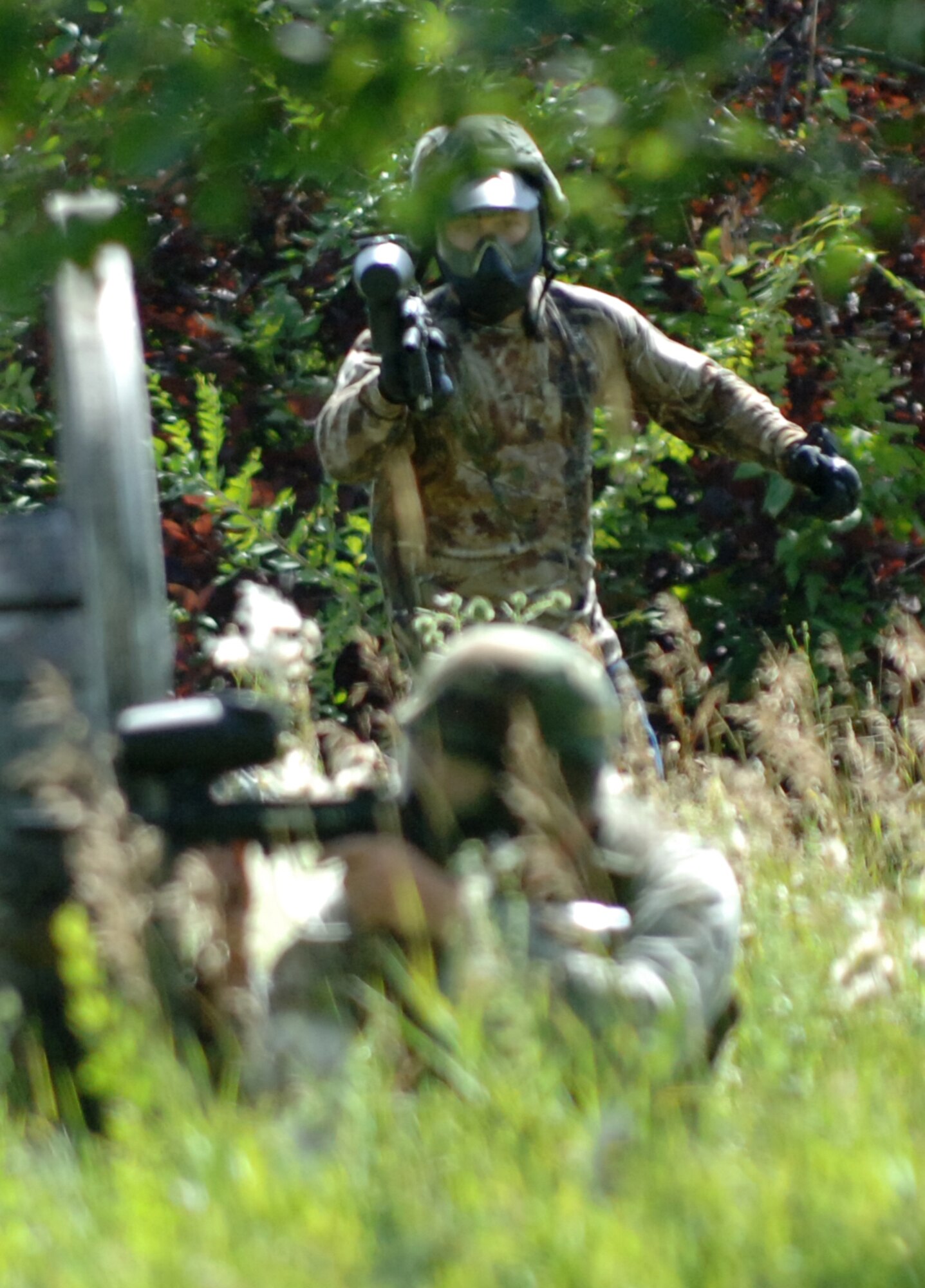 Airman 1st Class Jonathan Turcotte, 319th Security Forces Squadron installation entry controller, sneaks behind his opponent for a surprise attack in a game of paintball during the annual combat readiness training Aug. 2 at the Grand Forks Air Force Base paintball course. The mandatory training included a refresher course in evasive maneuvers and tactical movement, and culminated in a demonstration of skills during a game of paintball. (U.S. Air Force photo by Airman 1st Class Rachel Martinez)