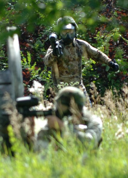 Airman 1st Class Jonathan Turcotte, 319th Security Forces Squadron installation entry controller, sneaks behind his opponent for a surprise attack in a game of paintball during the annual combat readiness training Aug. 2 at the Grand Forks Air Force Base paintball course. The mandatory training included a refresher course in evasive maneuvers and tactical movement, and culminated in a demonstration of skills during a game of paintball. (U.S. Air Force photo by Airman 1st Class Rachel Martinez)