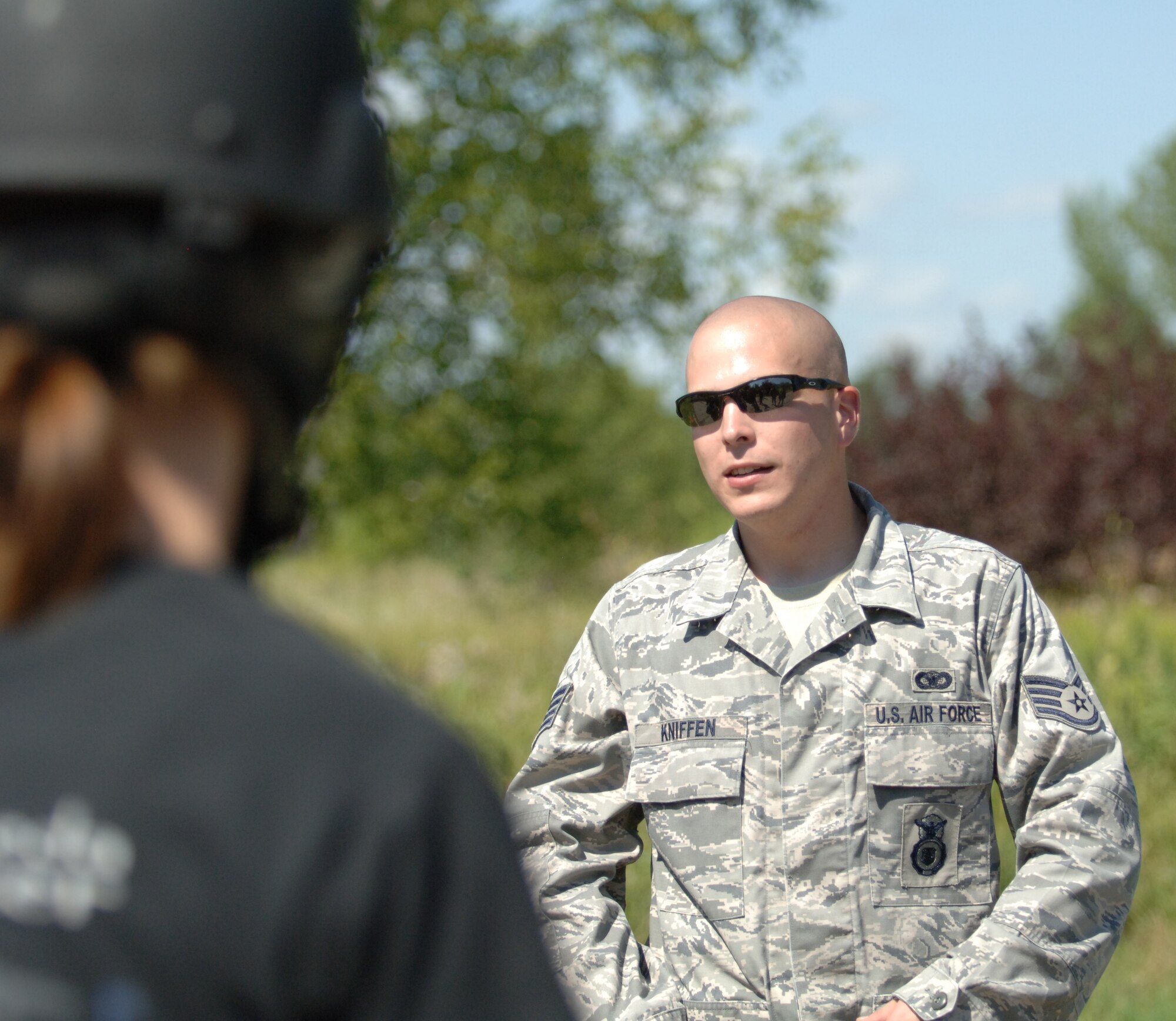Staff Sgt. Matthew Kniffen, 319th Security Forces Squadron and annual combat readiness trainer, instructs training participants in the annual combat readiness training Aug. 2 at the Grand Forks Air Force Base paintball course. The mandatory training included a refresher course in evasive maneuvers and tactical movement, and culminated in a demonstration of skills during a game of paintball. (U.S. Air Force photo by Airman 1st Class Rachel Martinez)