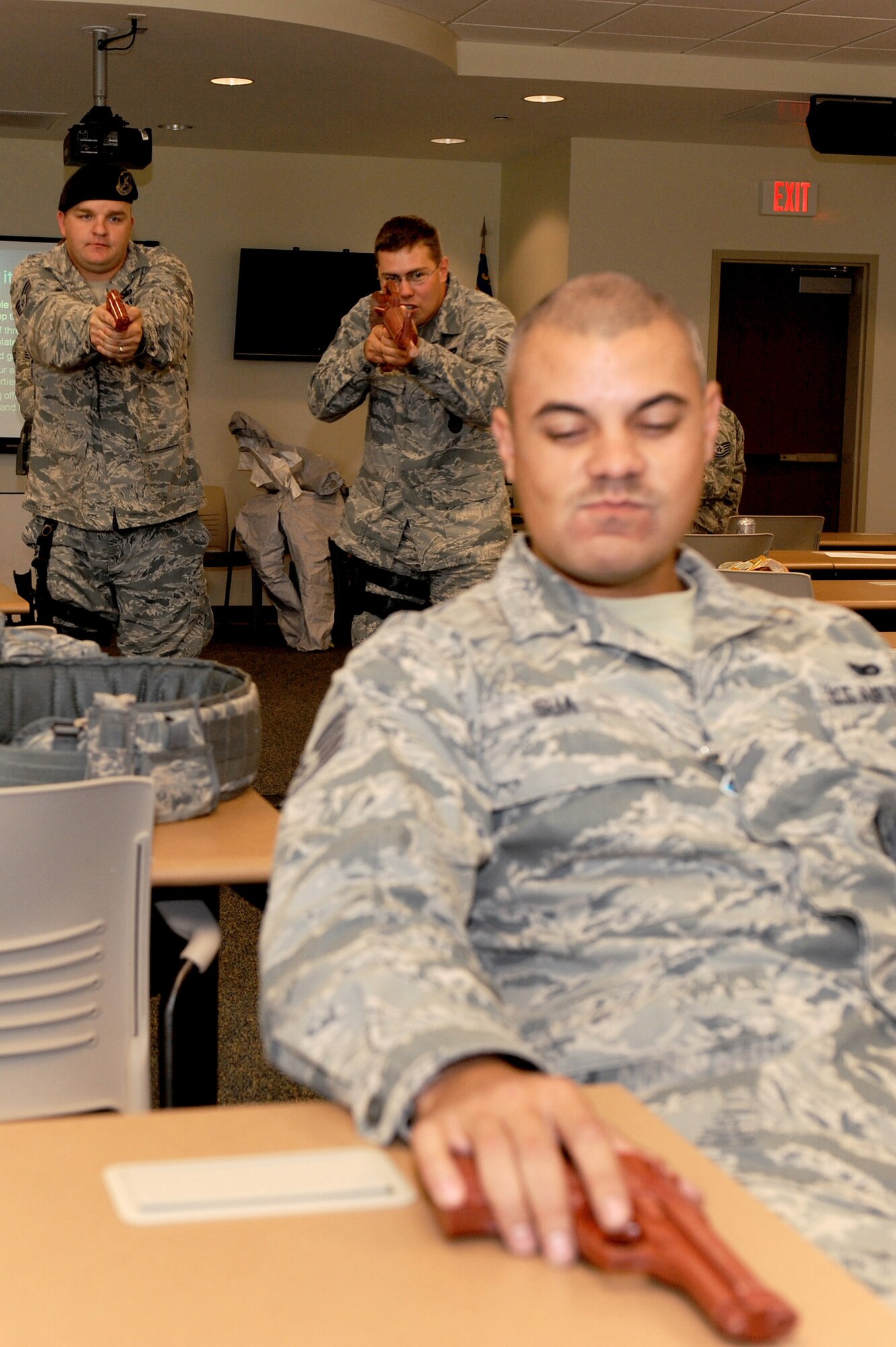 375th Security Forces personnel surround an "asailant" with a weapon during a training exercise at Scott AFB, July 21, 2010. The exercise showed security forces tactics for entering and clearing a room and helped to prepare all security forces officers for any situation when entering a reported disturbance scene. (U.S. Air Force photo by Staff Sgt. Brian J. Ellis)
