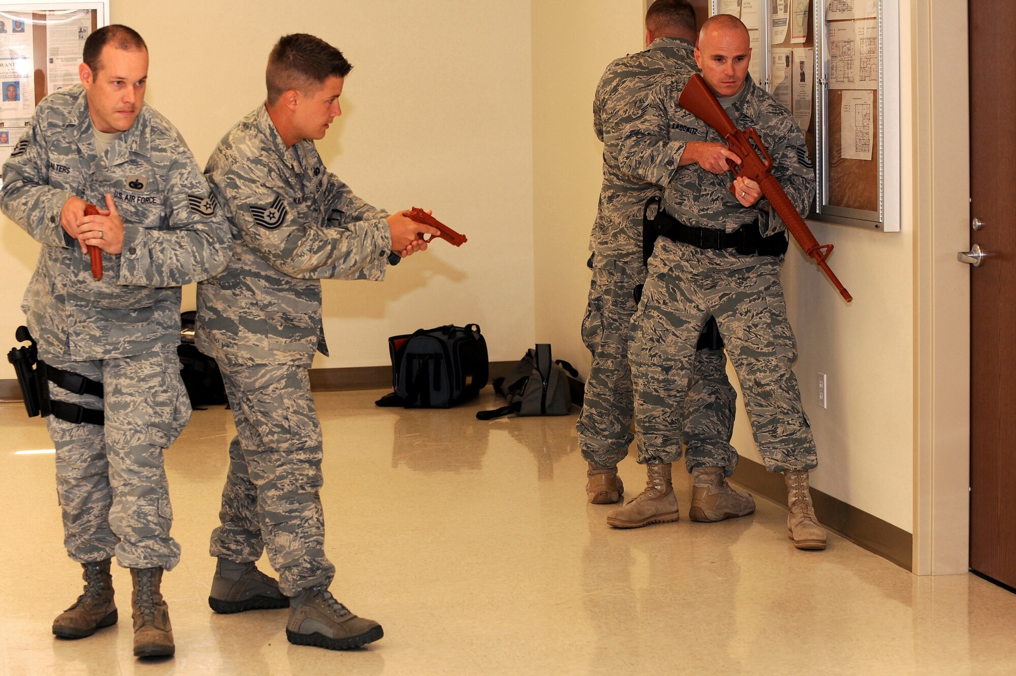 Tech. Sgt. Paul Kilquist, 375th Security Forces Squadron, instructs fellow SFS Airmen on tactics for entering and clearing a room at Scott AFB, July 21, 2010. Sergeant Kilquist is a reservist assigned to the 375th SFS and brings experience from his job as a police officer in Collinsville, Ill. The instruction is designed to prepare all security forces officers for any situation when entering a reported disturbance scene. (U.S. Air Force photo by Staff Sgt. Brian J. Ellis)