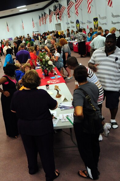 BARKSDALE AIR FORCE BASE, La. -- Parents and children make their way through rows of booths showcasing local schools during the Operation School Days event held at Hoban Hall August 2. The event was hosted by the Barksdale Youth Center, Barksdale Community Education Partnership and the Airman and Family Readiness Center. (U.S. Air Force photo by Senior Airman Joanna M. Kresge)