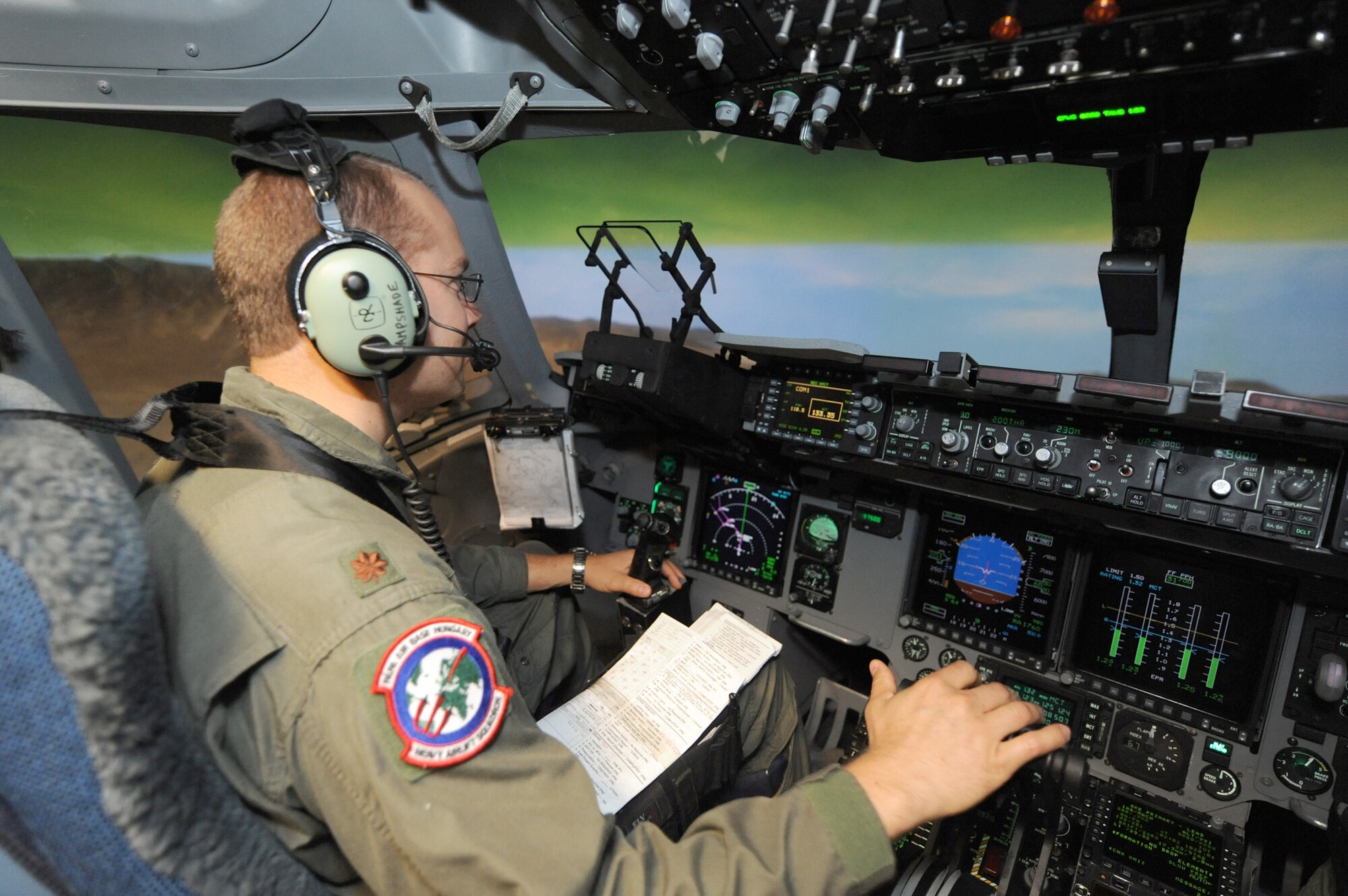 Maj. Brian Nicosia conducts training in the C-17 Globemaster III simulator June 21, 2010, on Joint Base Charleston, S.C. Major Nicosia is the chief of tactics with the Heavy Airlift Wing at Pápa Air Base, Hungary, and is visiting Joint Base Charleston for quarterly pilot training. (U.S. Air Force photo/James M. Bowman)