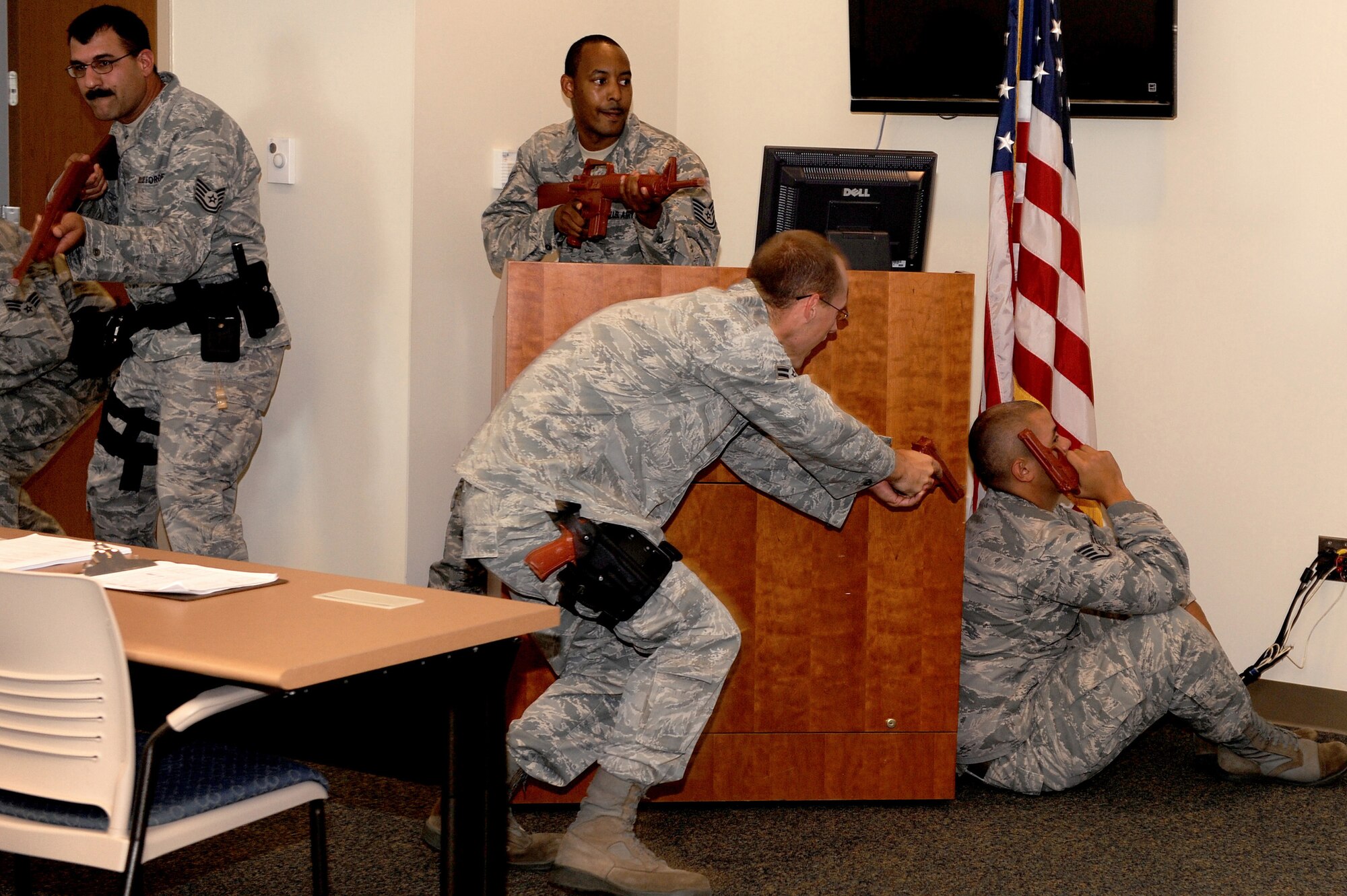 375th Security Forces personnel surround an "asailant" with a weapon during a training exercise at Scott AFB, July 21, 2010. The exercise showed security forces tactics for entering and clearing a room and helped to prepare all security forces officers for any situation when entering a reported disturbance scene. (U.S. Air Force photo by Staff Sgt. Brian J. Ellis)