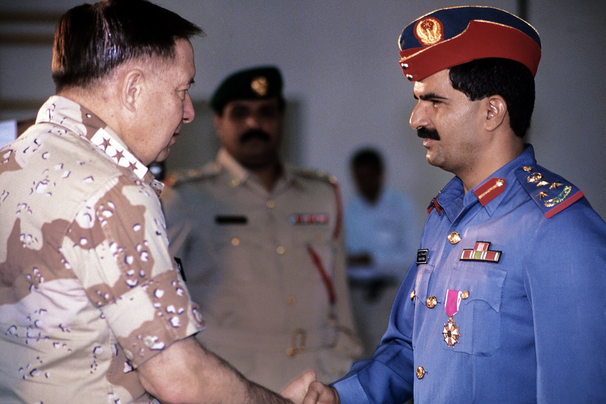 Lt. Gen. Charles A. Horner, former commanding general, U.S. Central Air Force, greets base commander Brig. Gen. Rashid Mubarek Al-Riamy during a tour of coalition forces after Operation Desert Storm.