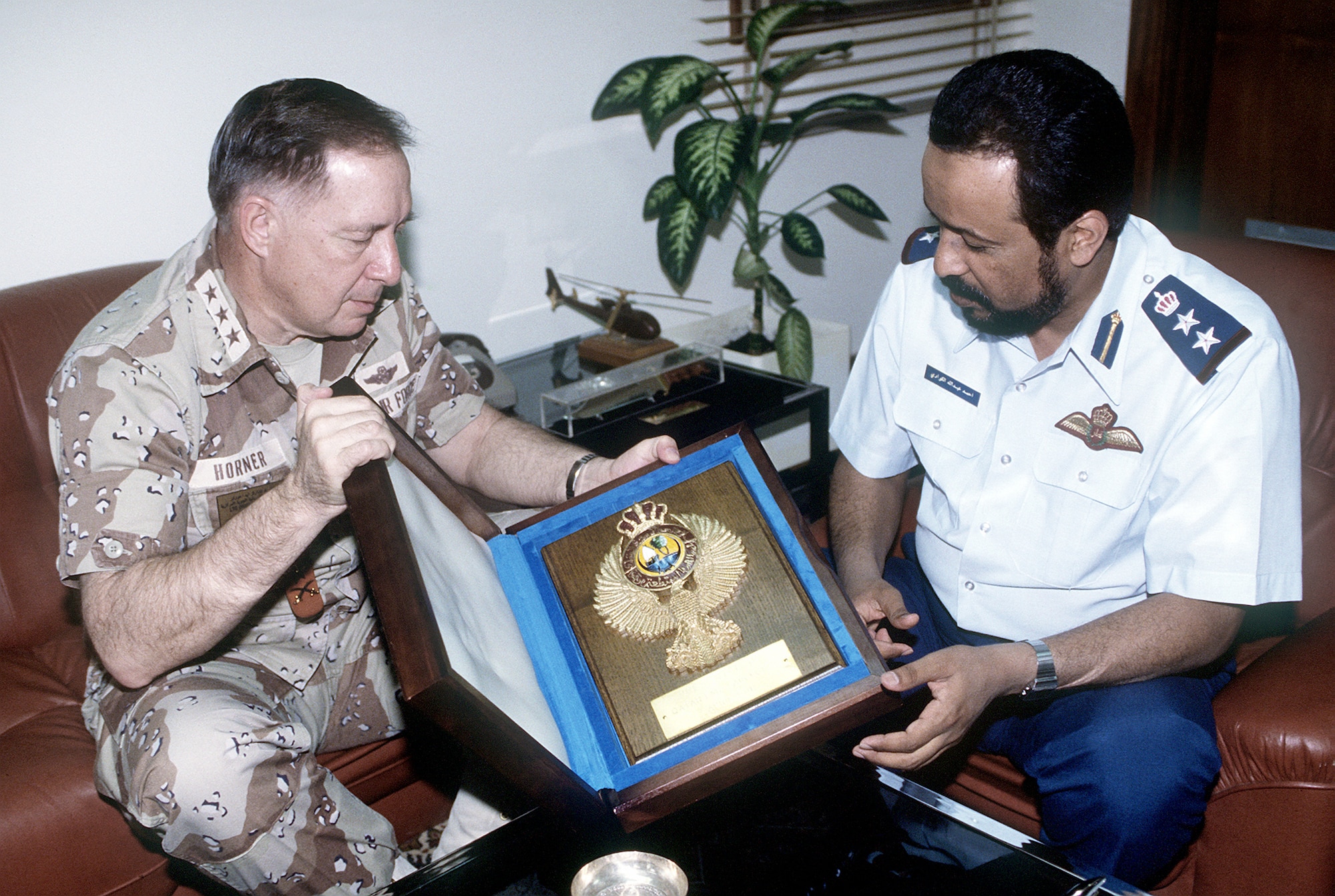 Lt. Gen. Charles Horner, commander of U.S. Central Command Air Forces, receives a plaque from Col. Ahmed Al-Kuwari, a Qatari commander, during a visit in the aftermath of Operation Desert Storm.  (Courtesy photo)