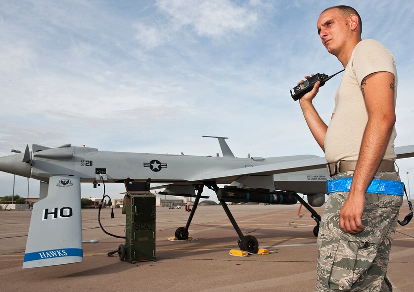 HOLLOMAN AIR FORCE BASE, N.M. -- Airman Steven Kleber, crew chief for 849th Aircraft Maintenance Squadron, listens to the pilot of the MQ-1 Predator performing the pre-launch procedure checklist June 7, 2010. Remotely Piloted Aircraft pilots were recently given a glimpse into their field's future by Brig. Gen. David Goldfein, Director of Air and Space Operations, Headquarters Air Combat Command, when he visited the base and conducted two briefings at the base theater. General Goldfein outlined the RPA operator's current situation and his proposals to top Air Force leaders to normalize RPA operations. (U.S. Air Force photo by Senior Airman DeAndre Curtiss / Released) 