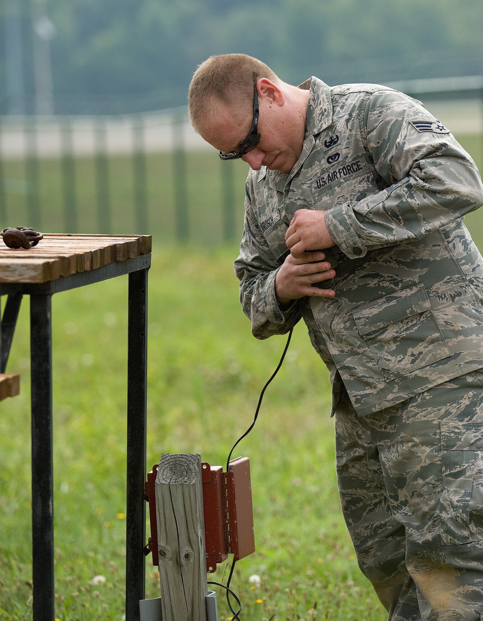 Senior Airman John Larosch, 512th Civil Engineer Squadron Explosive Ordnance Disposal technician, tests a circuit on a piece of ordnance before setting it off at the EOD range here, July 29. Airman Larosch is one of seven reservists assigned to the 512th EOD Flight. (U.S. Air Force photo/Jason Minto) 