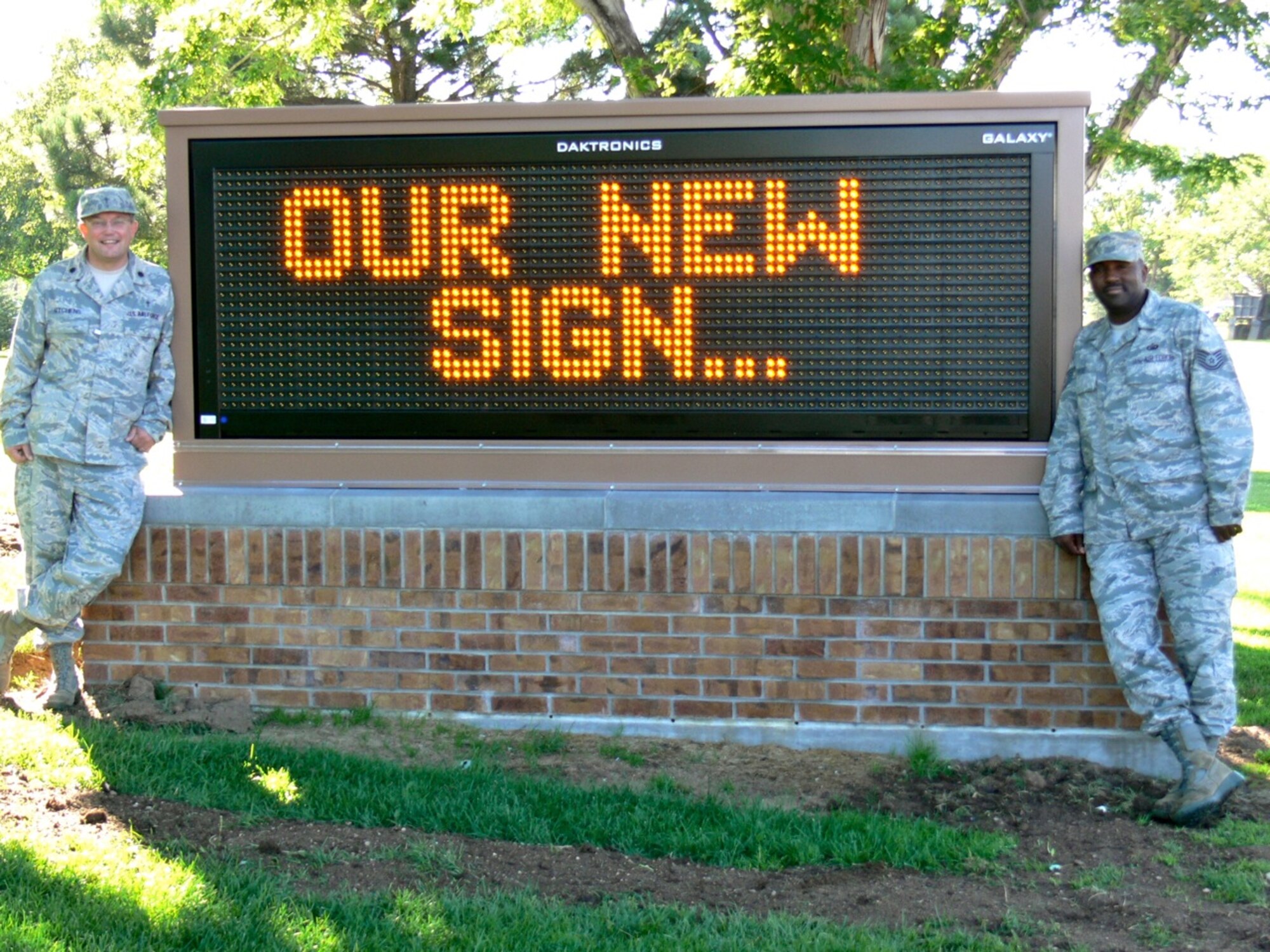 Chaplain (Lt. Col.) Randall Kitchens, 21st Space Wing chaplain, and Tech. Sgt. Shayne Hyde, noncommissioned officer in charge of chapel readiness and resources, show off the new electronic marquee at the Peterson Chapel. The new sign tops off a year’s worth of renovation projects at the chapel which included updated lighting and sound in the sanctuary, an overhaul of the kitchen and a revamp of old unused space into meditation rooms and family counseling rooms. (U.S. Air Force photo/Monica Mendoza) 