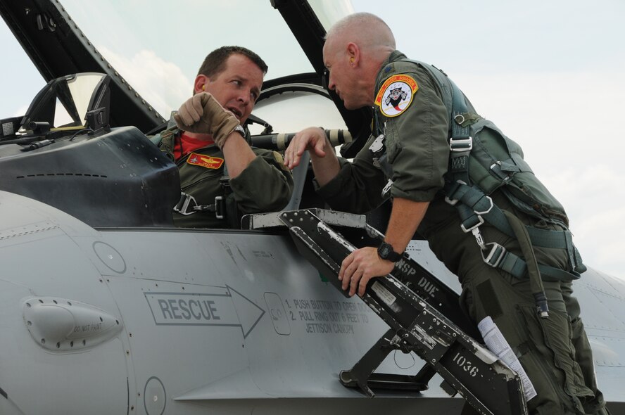 Lt. Col Nathan Thomas and Lt. Col John Thompson discuss prepartions for the final flights at Springfield Air National Guard base on July 30, 2010.  Colonel Thomas and Thompson were taking their final flights in F-16s before the planes were moved to a new base.(U.S. Air Force photo by Tech. Sgt. Seth Skidmore/Released) 