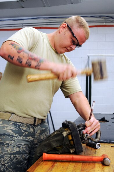 BARKSDALE AIR FORCE BASE, La. -- Senior Airman Jason Bousman, 2d Operational Support Squadron aircrew flight equipment technician, repairs a drag-chute July 29. Each B-52 has 11 parachutes and 10 survival kits. (U.S. Air Force photo by Senior Airman Brittany Y. Bateman)(RELEASED) 