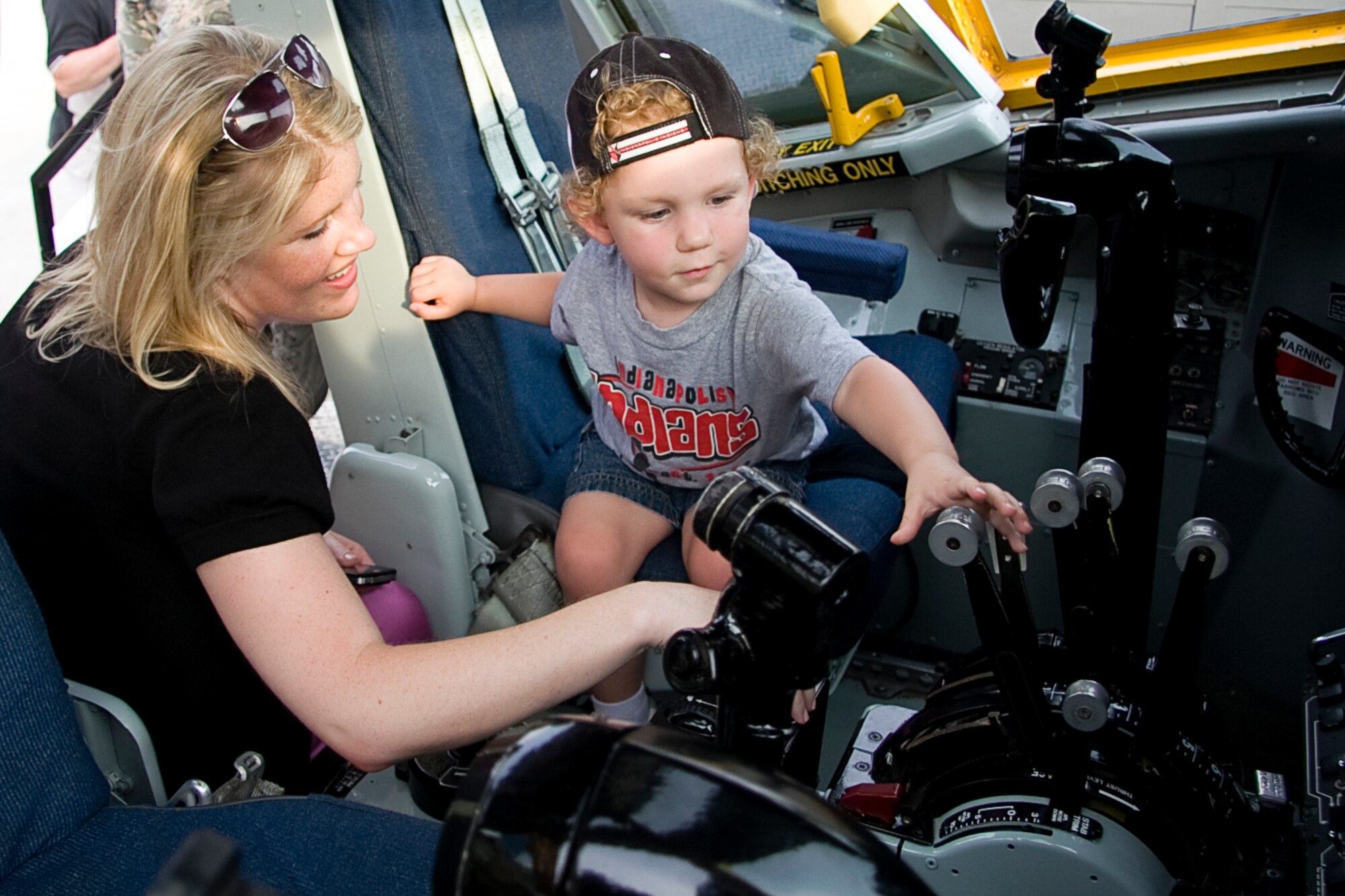 GRISSOM AIR RESERVE BASE, Ind. -- John Haworth, 2, plays with the controls of a KC-135R Stratotanker display as family friend, Amanda Murray watches on. Both Mr. Haworth and Ms. Murray were able to take their turn getting inside a Stratotanker cockpit during an Indianapolis Indians Game July 22. Members of the 434th Air Refueling Wing along with Air Force Reserve Command recruiters took part in various activities throughout the night, promoting the Air Force Reserve. (U.S. Air Force photo/Tech. Sgt. Mark R. W. Orders-Woempner) 