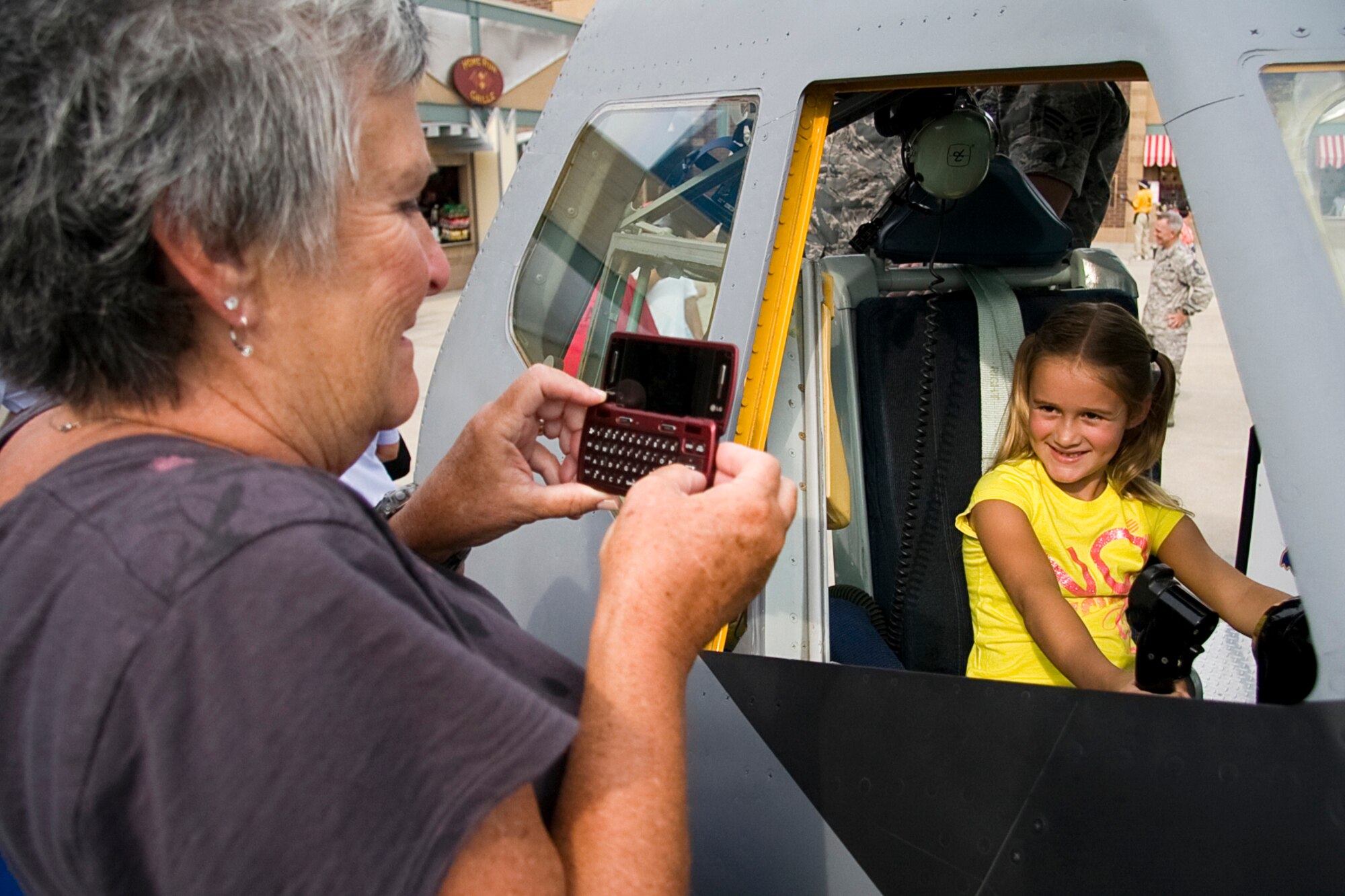 GRISSOM AIR RESERVE BASE, Ind. -- Sherry Johnson, better known to her six-year old granddaughter Kennedy Fisher as "GaGa"  takes a photo of Ms. Fisher as she sits in a flight deck simulator of a KC-135R Stratotanker during an Indianapolis Indians baseball game July 22. Members of the 434th Air Refueling Wing along with Air Force Reserve Command recruiters took part in various activities throughout the night, promoting the Air Force Reserve. (U.S. Air Force photo/Tech. Sgt. Mark R. W. Orders-Woempner) 