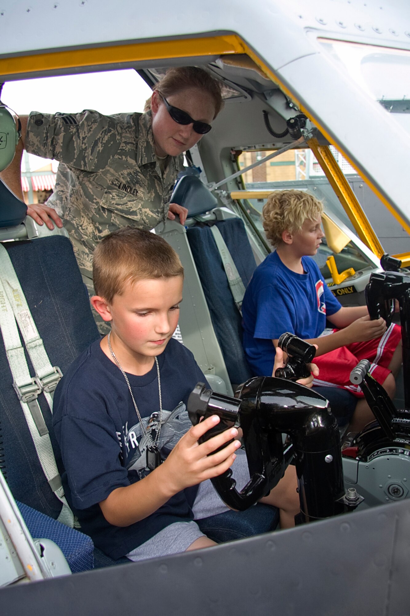 GRISSOM AIR RESERVE BASE, Ind. -- Josh Worman, 8 takes his turn at the controls of a KC-135R Stratotanker simulator as Senior Airman Sarah Lindley watches on during an Indianapolis Indians game at Victory Field in Indianapolis July 22. Airman Lindley is an integrated avionics systems apprentice with the 434th Aircraft Maintenance Squadron. Members of the 434th Air Refueling Wing along with Air Force Reserve Command recruiters took part in various activities throughout the night, promoting the Air Force Reserve. (U.S. Air Force photo/Tech. Sgt. Mark R. W. Orders-Woempner) 