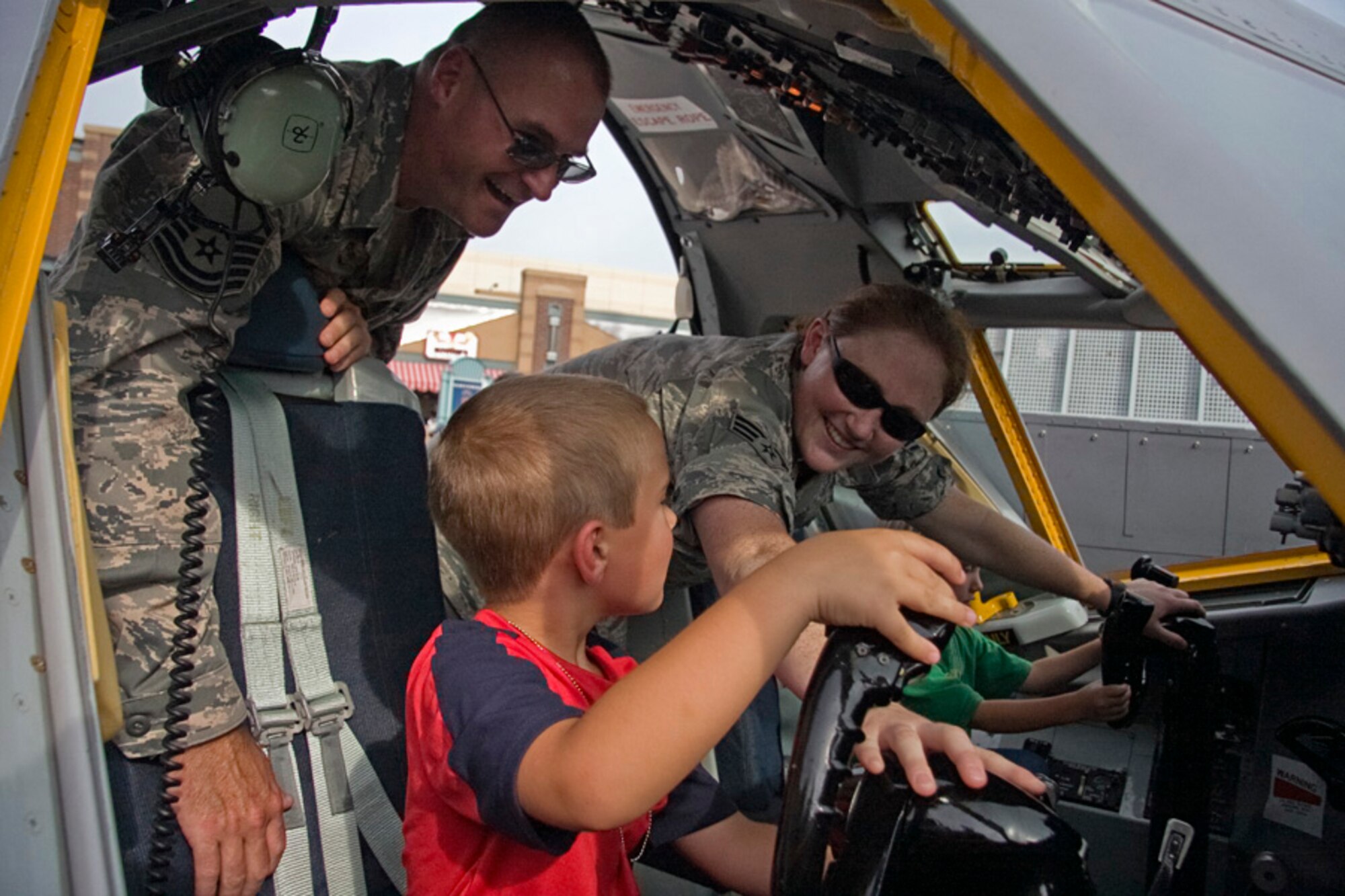 GRISSOM AIR RESERVE BASE, Ind. -- Master Sgt. Todd Moore and Senior Airman Sarah Lindley show Taylor Mann, 6, and Connor Mann, 3, how the various controls in a KC-135R Stratotanker work. The two boys were able to get a hands-on experience inside a KC-135 flight deck simulator at an Indianapolis Indians baseball game July 22, sponsored by the Air Force Reserve. Sergeant Moore is a KC-135 crew chief with the 434th Maintenance Squadron and Airman Lindley is an integrated avionics systems apprentice with the 434th Aircraft Maintenance Squadron. (U.S. Air Force photo/Tech. Sgt. Mark R. W. Orders-Woempner) 