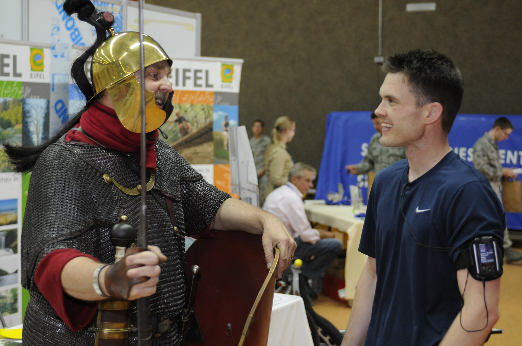 Gerald Wittwer, a foot soldier from the ancient Rome reenactment team the 22nd Legion, talks about the Bitburg Roman legion and life during Roman times to Staff Sgt. Ronnie Lambert, 52nd Operations Group knowledge operations manager. More than 150 exhibitors, representing communities and tourist agencies from the Eifel, surrounding areas and the countries of Luxembourg and Belgium, offered travel and leisure packages at this year’s Explore the Eifel Fair. Explore the Eifel takes place for the sixth time this year.  Events to acquaint servicemembers and their families are scheduled for Aug. 6-8. (U.S. Air Force photo/Senior Airman Clay Murray)