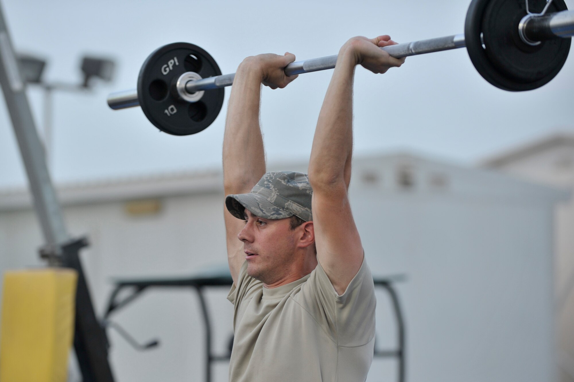 Senior Airman Randy Gonce, 380th Expeditionary Civil Engineer Squadron, demonstrates how to properly perform a weightlifting technique during the Fight Gone Bad Crossfit Challenge at an undisclosed location in Southwest Asia. (U.S. Air Force phot/Tech. Sgt. April Wickes)