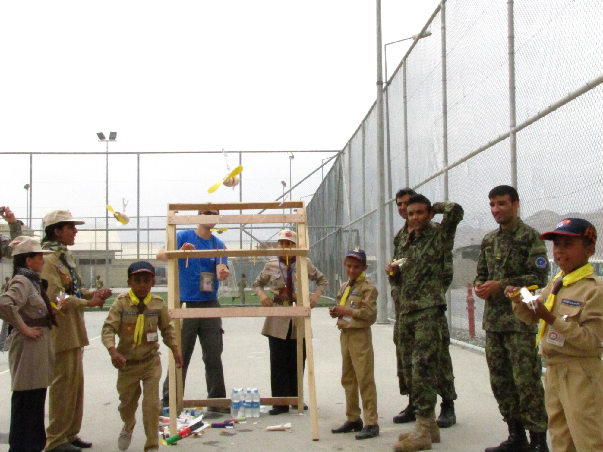 KABUL, Afghanistan - Members of the Afghan Scouts and Afghan Air Force Lieutenants race space rockets made of miniature balsa wood that are propelled by a rubber band and propeller along a taut fishing line on Aug 1st, 2010. (U.S. Air Force photo by Capt. Rob Leese/RELEASED).
