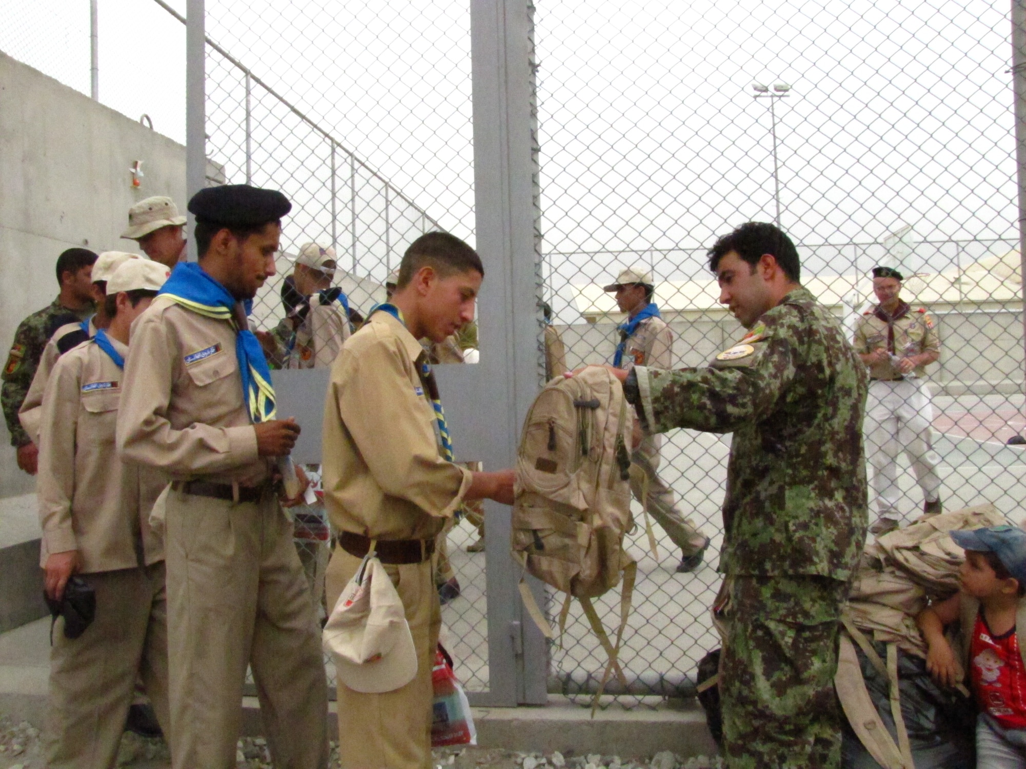 KABUL, Afghanistan - Afghan Air Force Lieutenants provided a new backpack filled with school supplies to each scout as they leave the Space Rocket Derby on ISAF Joint Command Base on Aug 1st, 2010. (U.S. Air Force photo by Capt. Rob Leese/RELEASED).