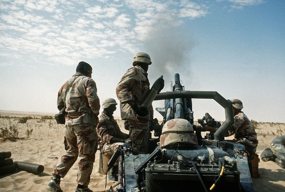 A U.S. Army soldier assigned to the 1st Battalion, 325th Airborne Infantry Regiment, prepares to load a 105mm shell into an M-102 towed howitzer during a heavy artillery barrage demonstration for Saudi Arabian national guardsmen during Desert Shield.