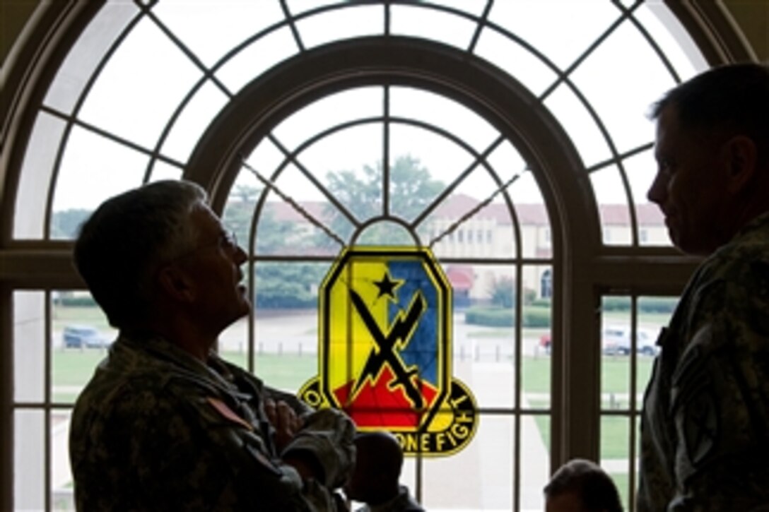Chief of Staff of the Army Gen. George W. Casey Jr. and Maj. Gen. Mike Ferriter scan the portraits of past commanders of the Maneuvers Centers of Excellence at Fort Benning, Ga., on Aug. 2, 2010.  