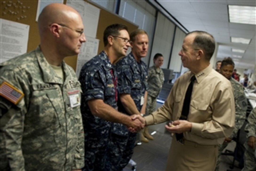 Chairman of the Joint Chiefs of Staff Adm. Mike Mullen, U.S. Navy, greets sailors assigned to the Deepwater Horizon Unified Command Center in New Orleans, La., on August 2, 2010.  Mullen and his wife Deborah visited the command and control center to receive an operational update and to thank the service members and civilians working to help contain the largest oil spill in U.S. history.  