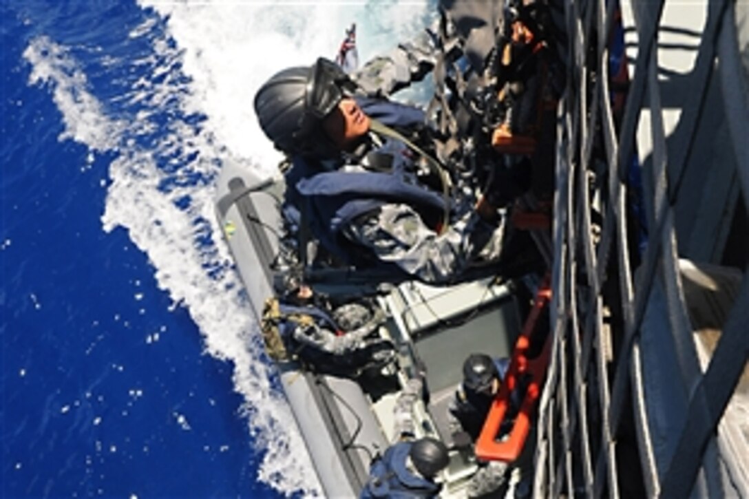 U.S. Navy sailors board the littoral combat ship USS Freedom to participate in a joint maritime security exercise. Freedom and Newcastle are participating in Rim of the Pacific 2010, the world's largest international maritime exercise in the Pacific Ocean, July 28, 2010. The sailors are assigned to the Australian navy guided-missile frigate HMAS Newcastle.