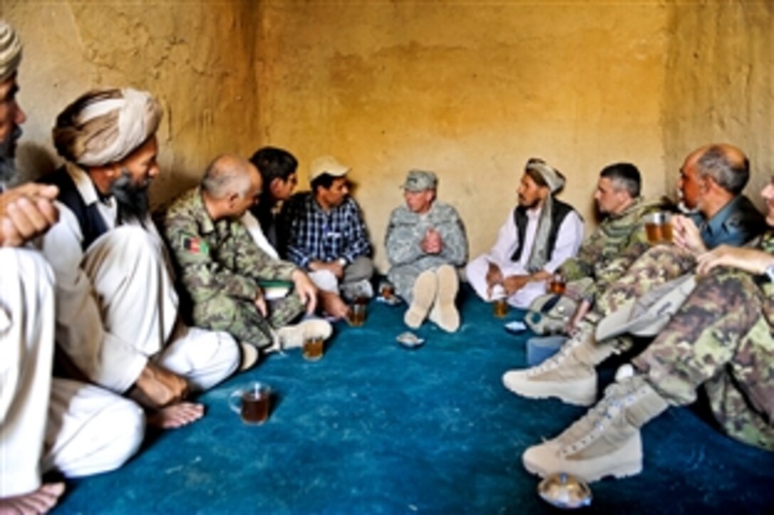 U.S. Army Gen. David H. Petraeus, center, commander of the International Security Assistance Force, meets with Afghans in the Bala Murghab valley of western Afghanistan, Aug. 2, 2010.