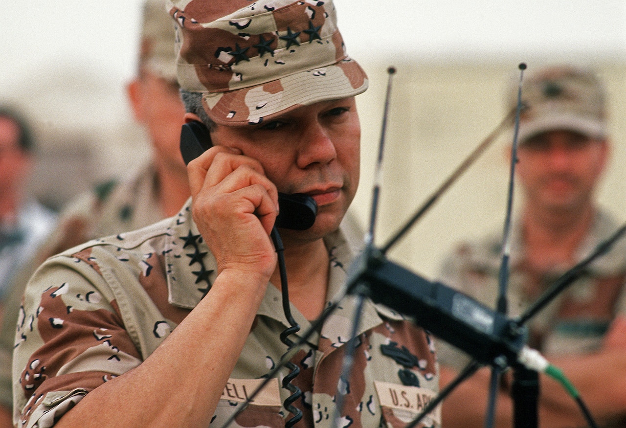 An Army general speaks on a phone.