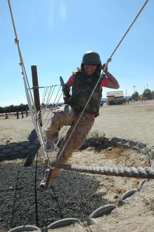 Lysa Ceballos, a counselor at East Union High School, attempts to overcome the rope bridge obstacle of the Bayonet Assault Course here, Aug., 3. One four man team, known as a fire-team, must move through each obstacle at a time and move as a team.