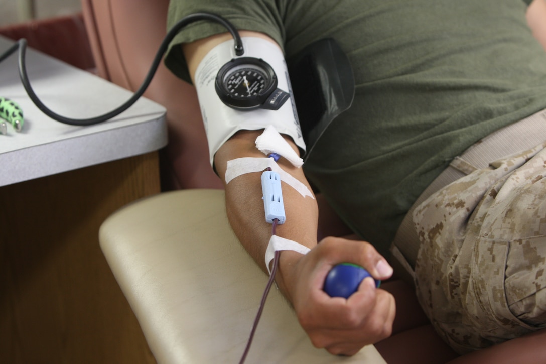 Pfc. Omero Vera, a recent graduate of D Company, Infantry Traing Battalion, School of Infantry- East, squeezes a stress ball every four seconds while donating blood inside the Armed Service Blood Program's mobile unit, parked just inside Camp Geiger, Aug. 5.