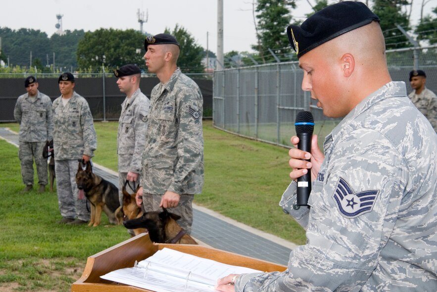 KUNSAN AIR BASE, Republic of Korea -- Staff Sgt. Jeffrey Tomkiewicz, 8th Security Forces Squadron member, reads the poem Guardians of the Night, in honor of two military working dogs, Damon and Bob, who each passed away recently. The 8th SFS held a memorial service in their honor Aug. 3 at the base kennels. (U.S. Air Force photo/Staff Sgt. Jonathan Pomeroy)