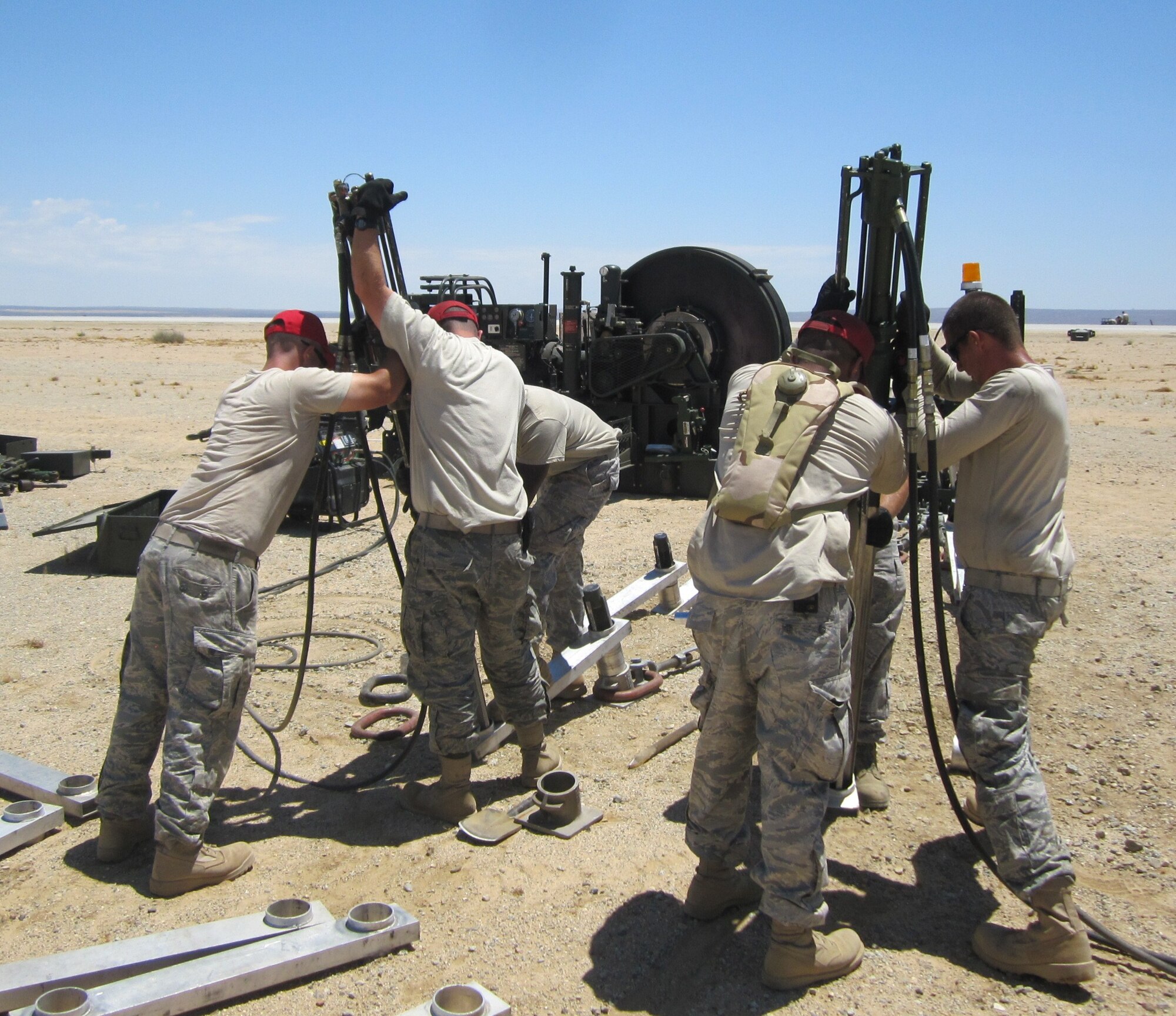 Airmen from 823rd and 820th RED HORSE perform stakeline installation on the mobile aircraft arresting system.  More than 150 66-inch stakes were installed to keep the MAAS in place. The team is made up of Airmen from Hurlburt Field, Fla. and Nellis Air Force Base, Nev.  The RED HORSE team installed the MAAS for the on-going Joint Strike Fighter brake testing. (Air Force photo) 