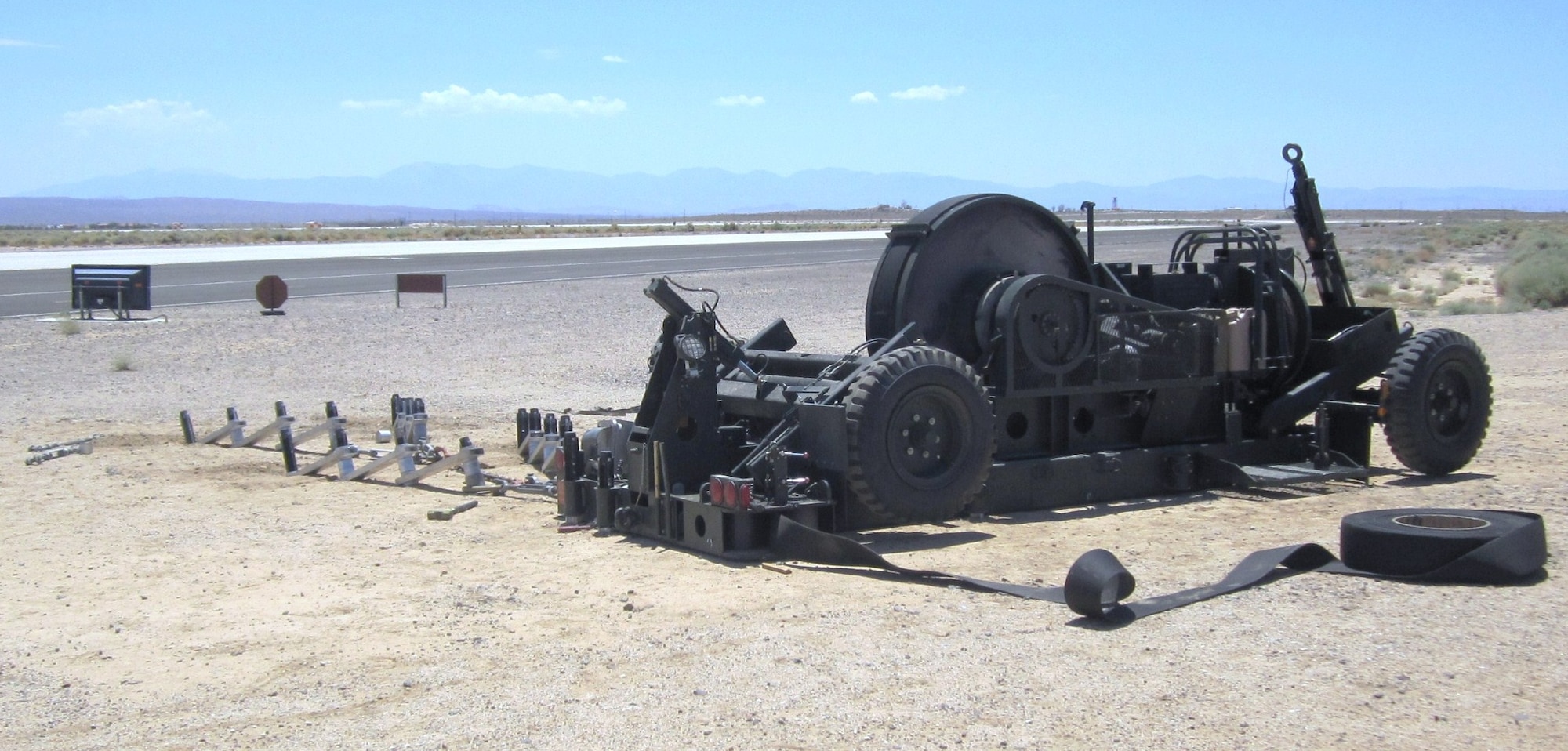 The mobile aircraft arresting system with all of its stakes installed to hold it in place, provides and additional measure of safety during Joint Strike Fighter brake testing.  The same system is set up on the other side of the runway.  The MAAS was installed by the 823rd and 820th RED HORSE out of Hurlburt Field, Florida, and Nellis Air Force Base, Nev. (Air Force photo) 