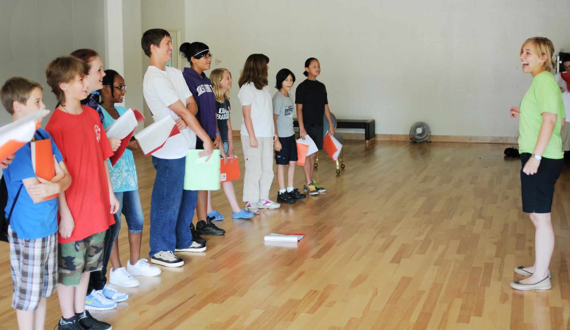 YOKOTA AIR BASE, Japan -- Emma Fyffe, Instructor with Missoula Children's Theatre, laughs with players from the production "The Frog Prince" about some of the words in a song they are learning. Showtime for "The Frog Prince" is scheduled for 6 August, 1800 at the Taiyo Community Center. (U.S. Air Force Photo/ Airman 1st Class Katrina R. Menchaca) 