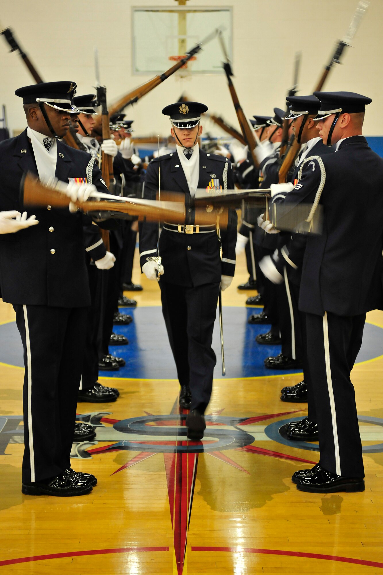 United States Air Force Honor Guard Drill Team Flight Commander, 1Lt. Chad Frey. (center) performs a signature move, referred to as walking the gauntlet at Cannon Air Force Base, N.M. Aug 4, 2010. The team visited to Cannon to entertain and recruit. About 80-85 percent of their manning comes from Basic Military Training and the rest from active duty Airmen. (U.S. Air Force photo by Tech Sgt. Josef Cole)(RELEASED)