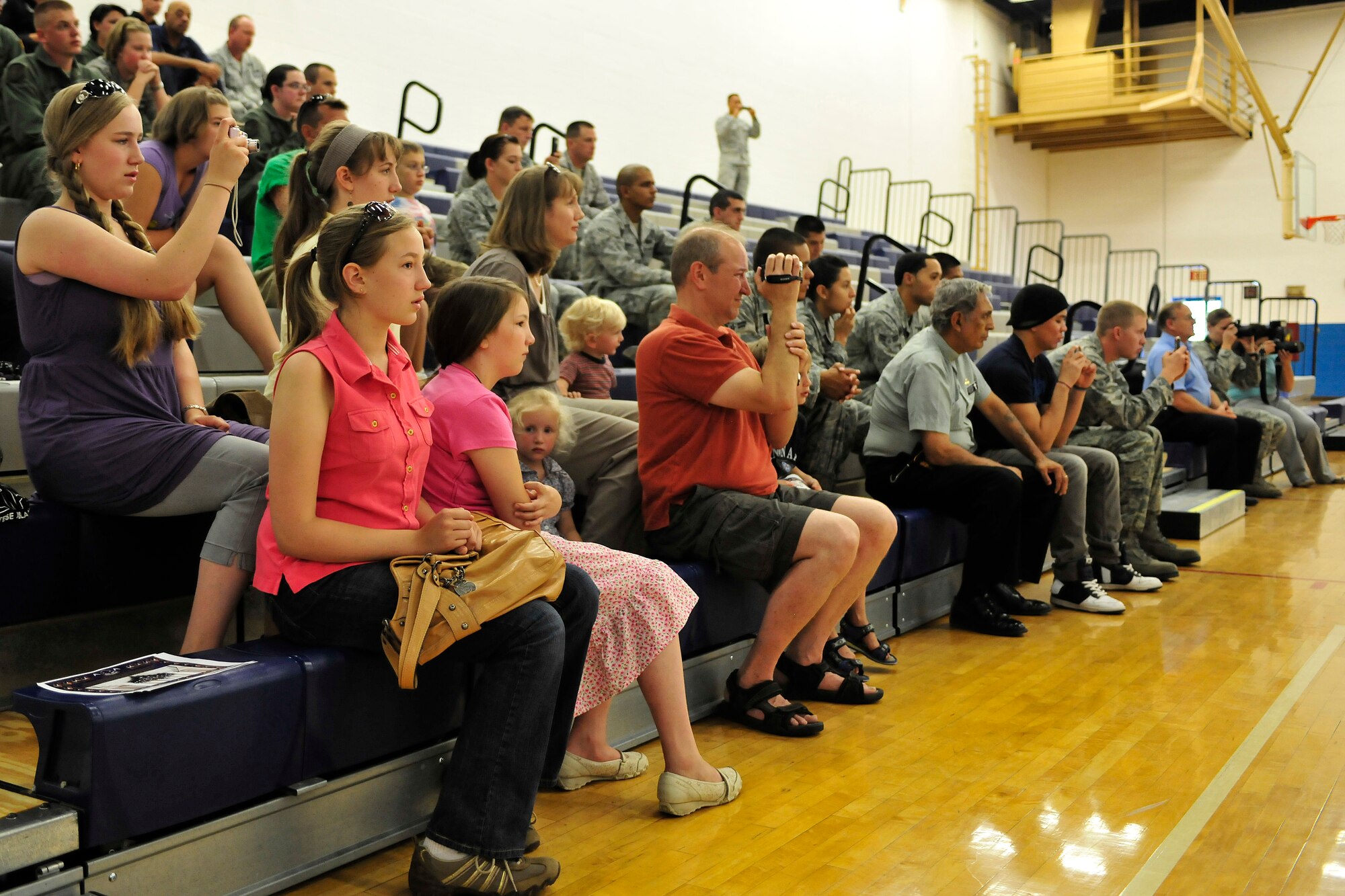 Spectators enjoy a performance by the United States Air Force Honor Guard Drill Team at Cannon Air Force Base, N.M. Aug 4, 2010. The team visited to Cannon to entertain and recruit. About 80-85 percent of their manning comes from Basic Military Training and the rest from active duty Airmen. (U.S. Air Force photo by Tech Sgt. Josef Cole)(RELEASED) 