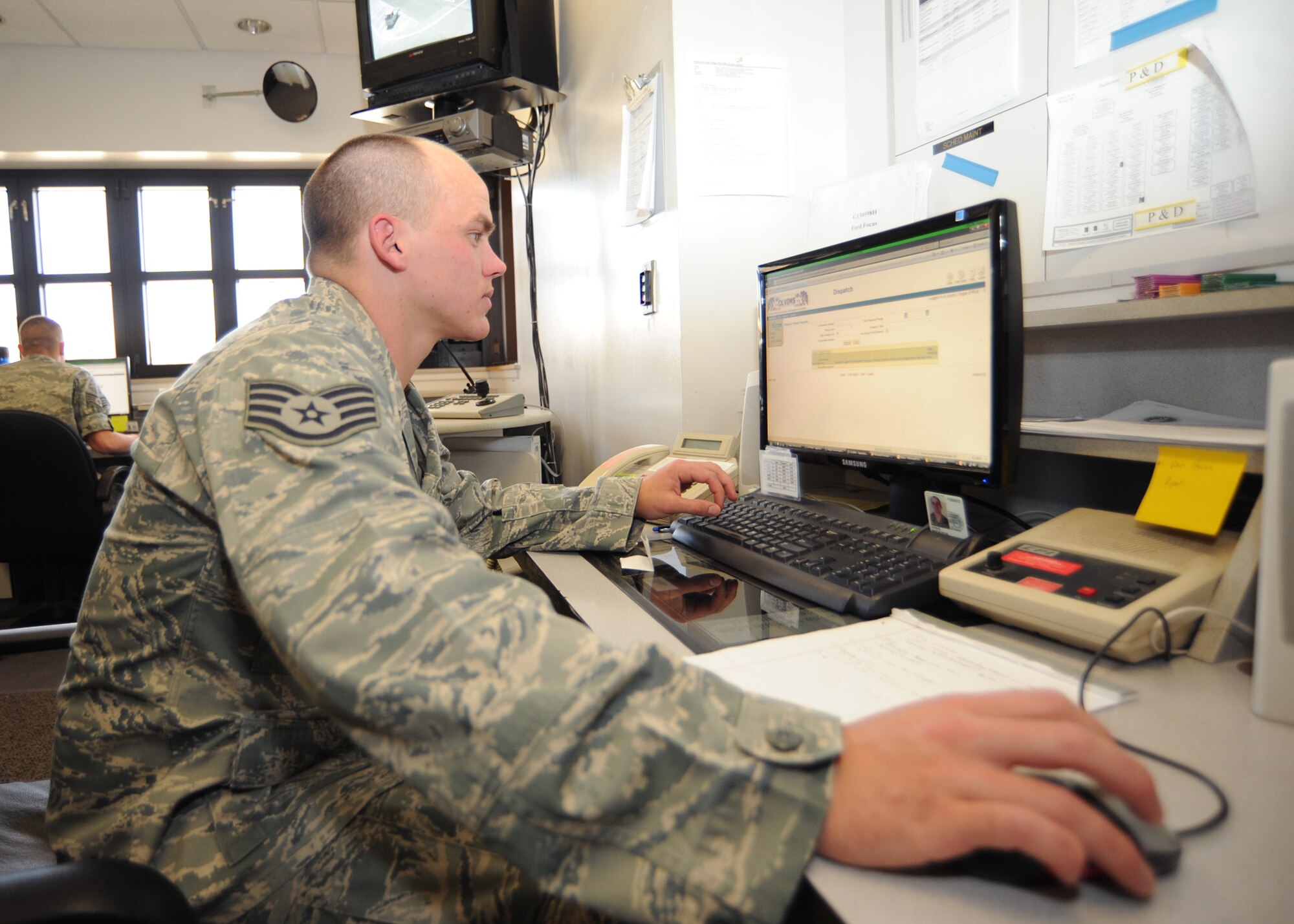 Staff Sgt. Austin Hogue, 22nd Logistics Readiness Squadron vehicle operations control dispatcher,  organizes dispatching requests at the vehicle operations control center Aug. 3, 2010, McConnell Air Force Base, Kan.  The control center averages approximately 900 vehicle requests a month.  Requests are submitted by the unit’s vehicle control officer through the McConnell vehicle operations SharePoint site.  (U.S. Air Force photo/Senior Airman Maria Ruiz)