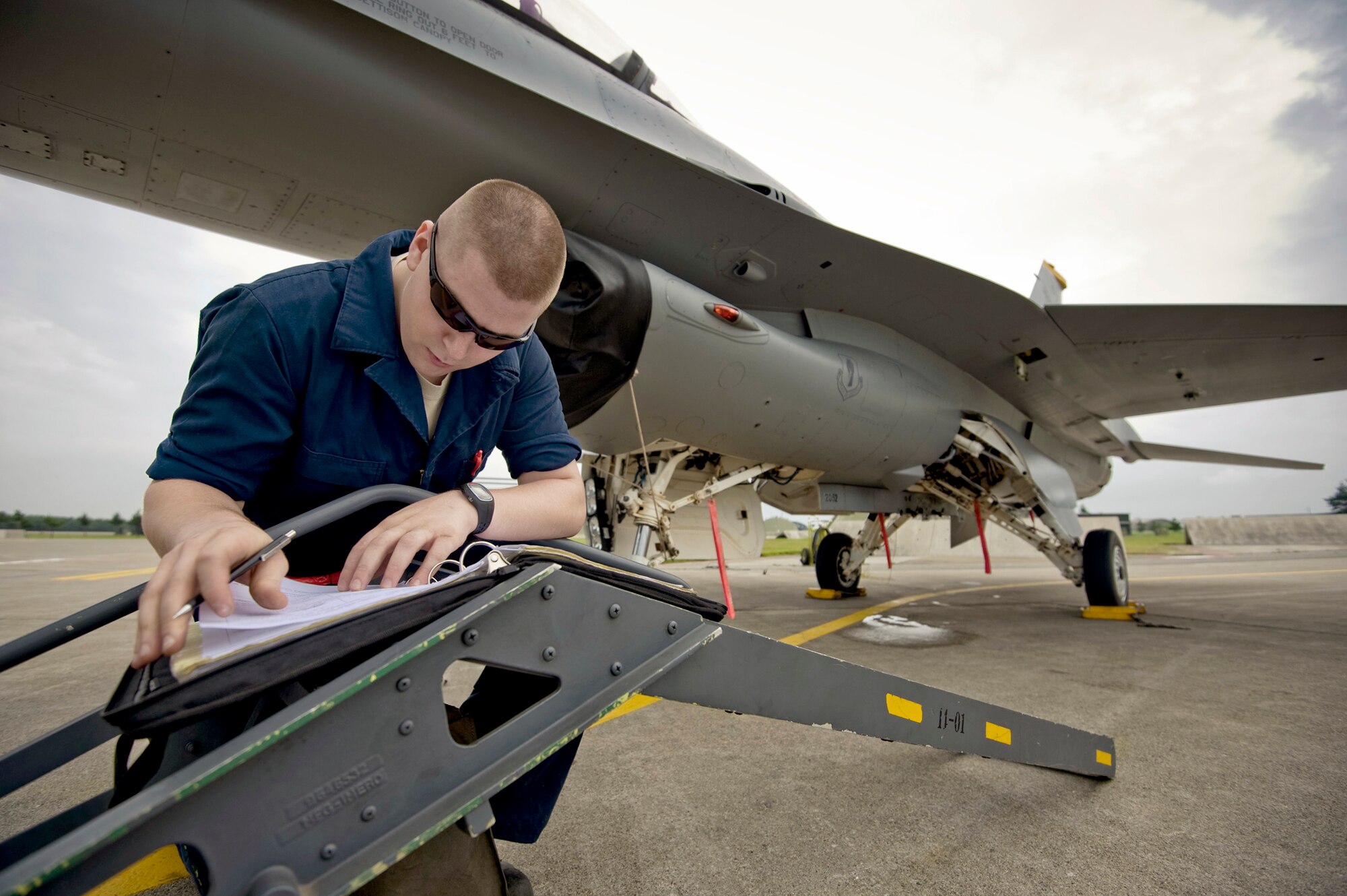 Airman 1st Class Patric Shaw completes maintenance logs on an F-16 Fighting Falcon following a training sortie Aug. 2, 2010, at Misawa Air Base, Japan.  Airman Shaw is with the 13th Aircraft Maintenance Unit. (U.S. Air Force photo/Staff Sgt. Samuel Morse)

